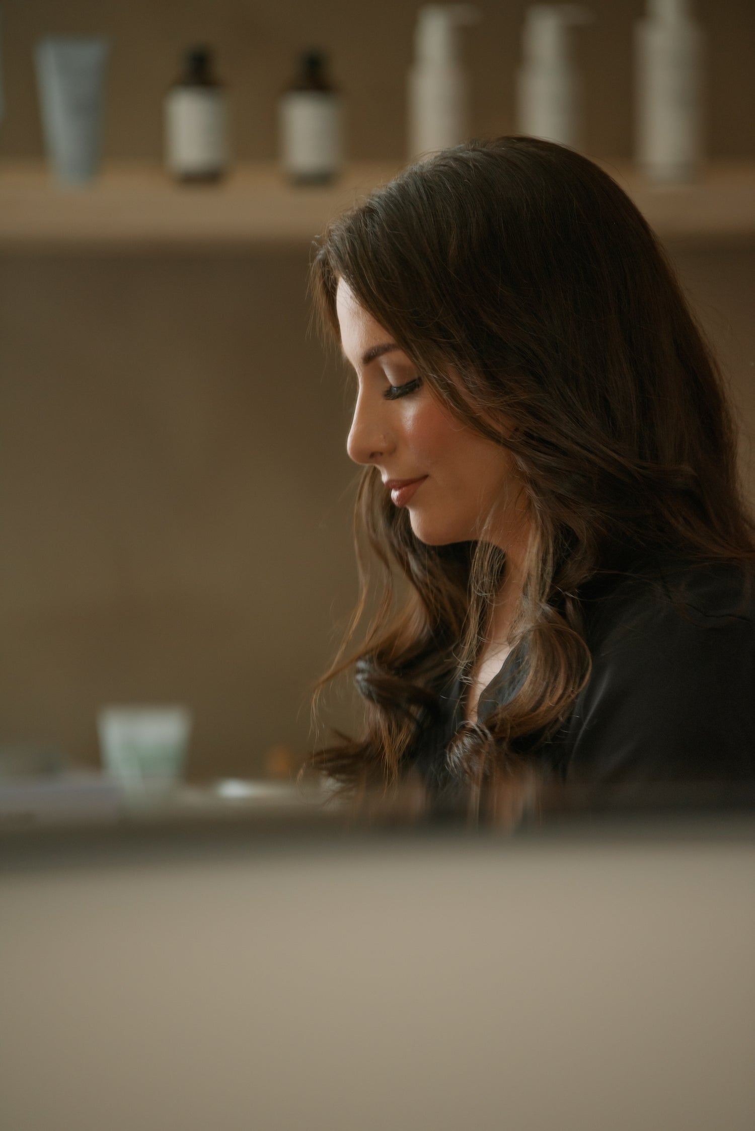 Esthetician preparing products at the studio counter before an appointment