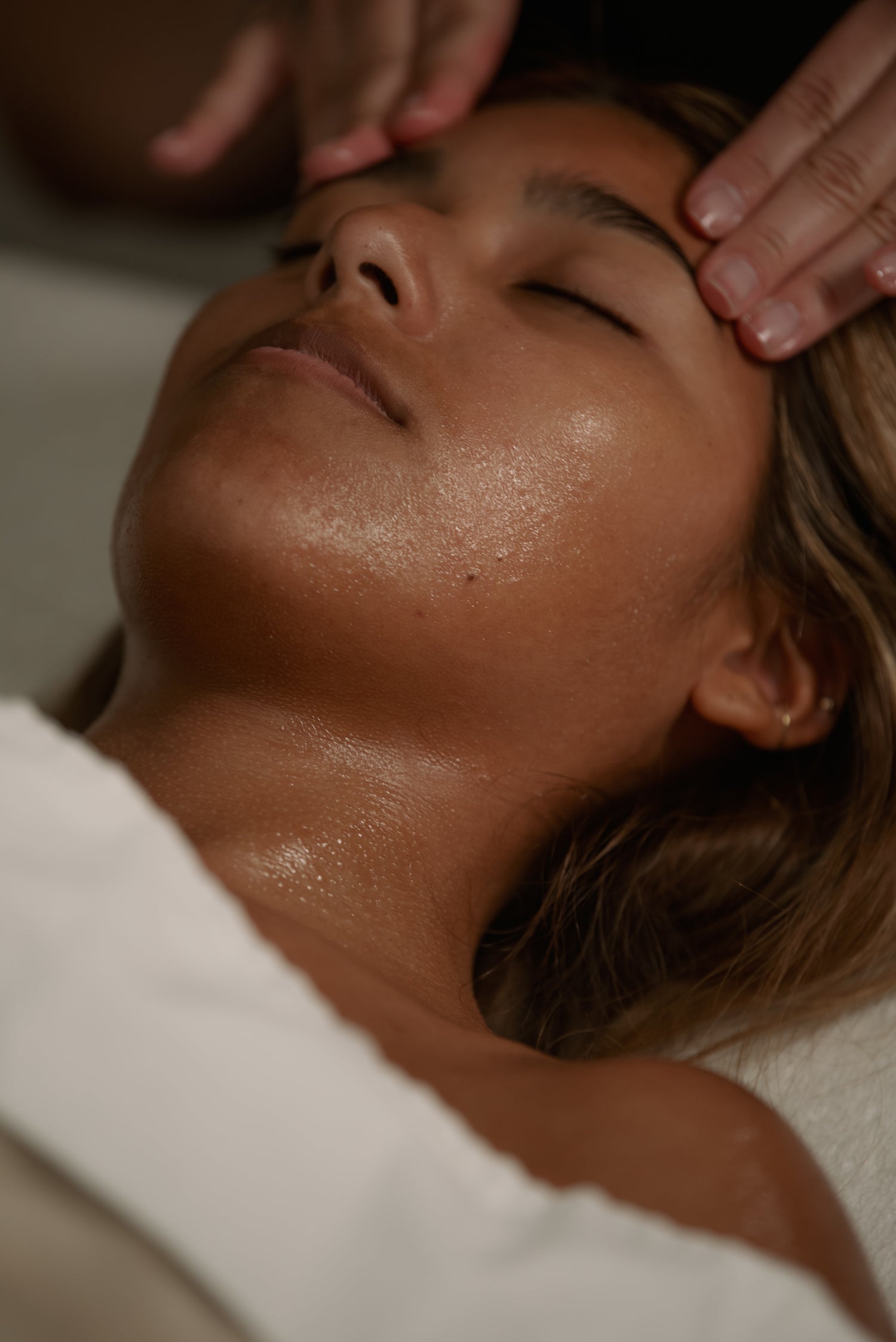 Close-up of a client's glowing skin during a relaxing facial massage