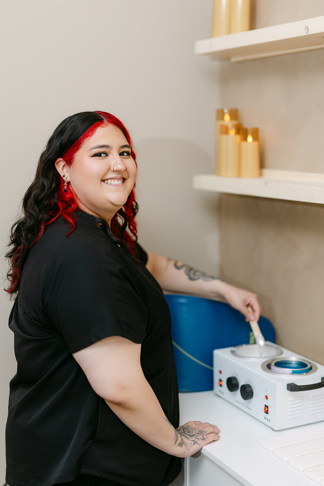 Yanelli, esthetician at Esthetics With Me, preparing warm wax for a waxing service
