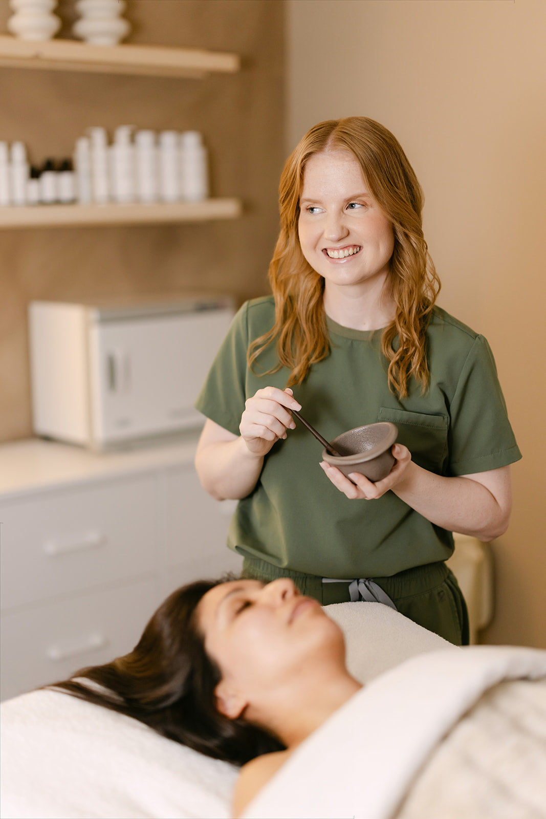 Shannon, esthetician at Esthetics With Me, mixing a custom mask for a client's facial